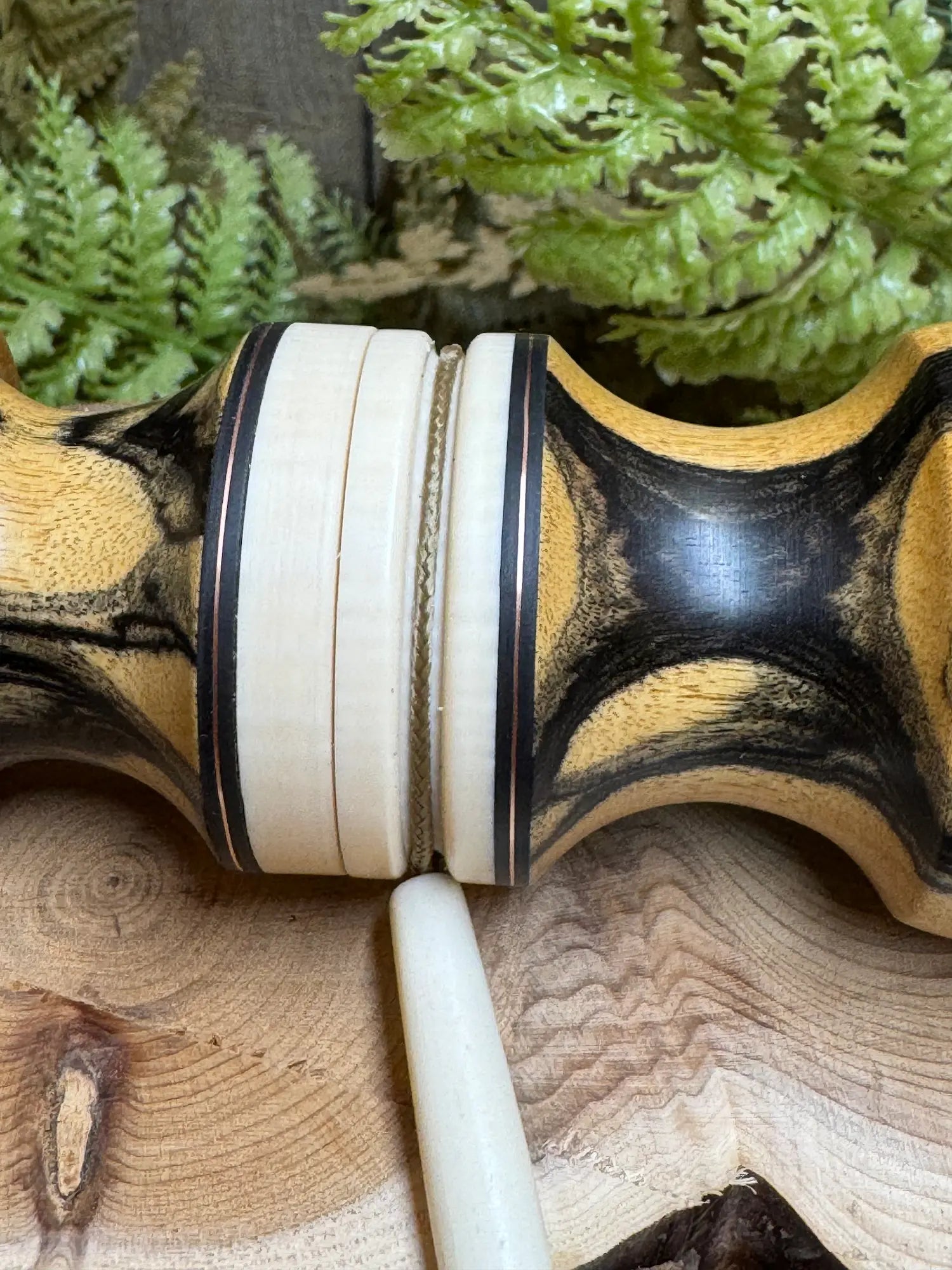 Black & White Ebony Deer Grunt - close up view of thread-together midline with inlays and lanyard groove