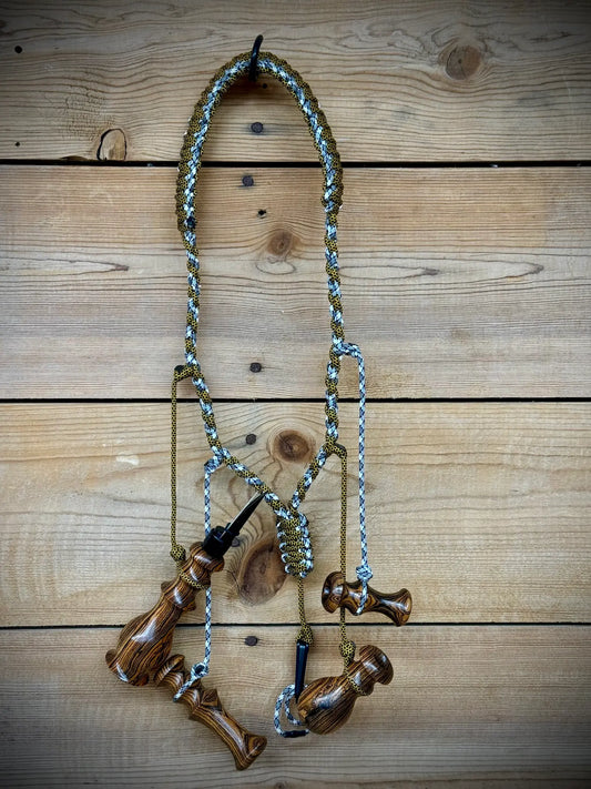 Bocote Predator Call Set Close Up View with rabbit squealer, coyote howler, fawn distress bleat, and rodent squeaker hanging from a custom made lanyard woven with aqua blue and yellow and black cords