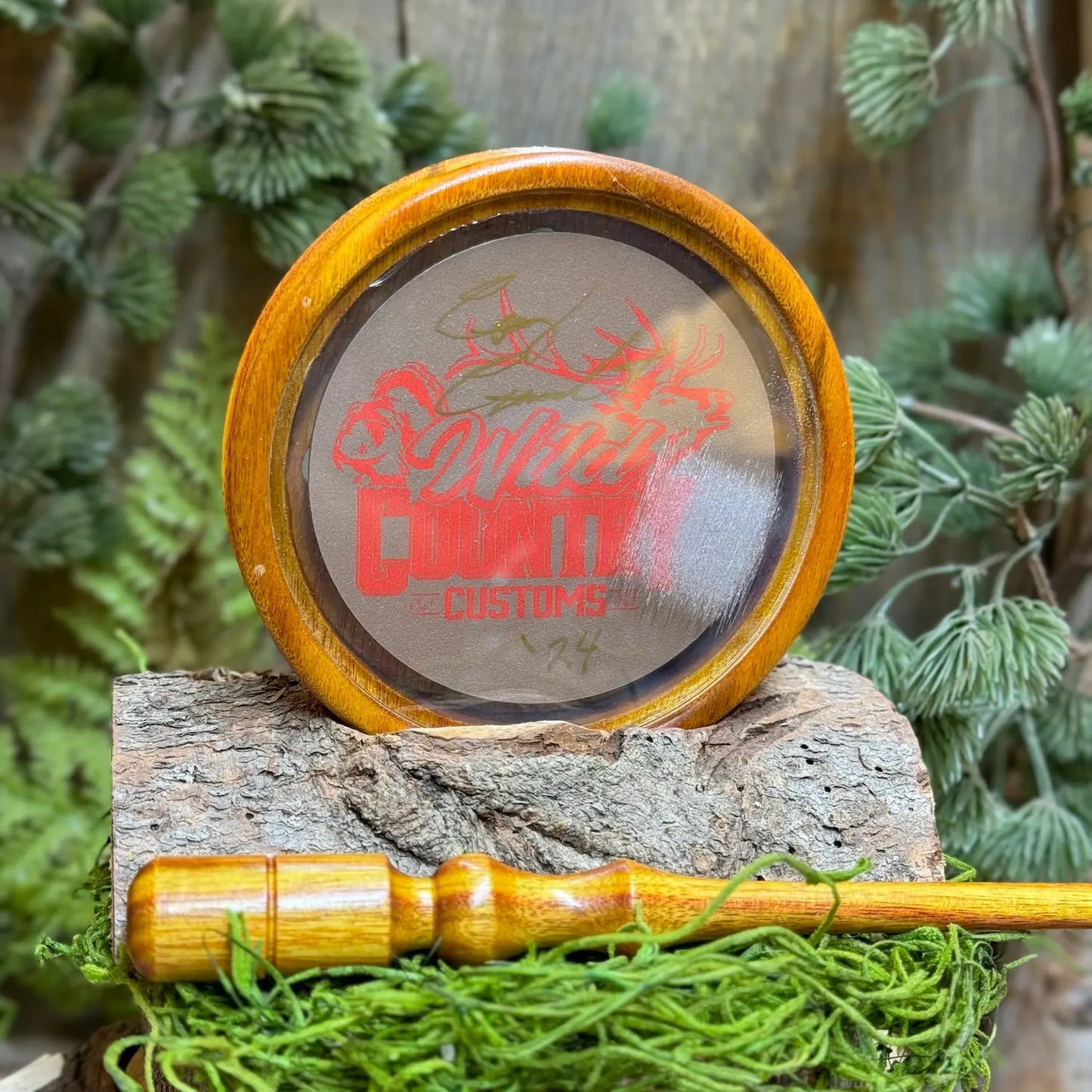 bright yellow and orange toned Canarywood Turkey Call showing glass surface preconditioned and signed with Wild Country Customs logo behind the glass and a matching canarywood striker in foreground