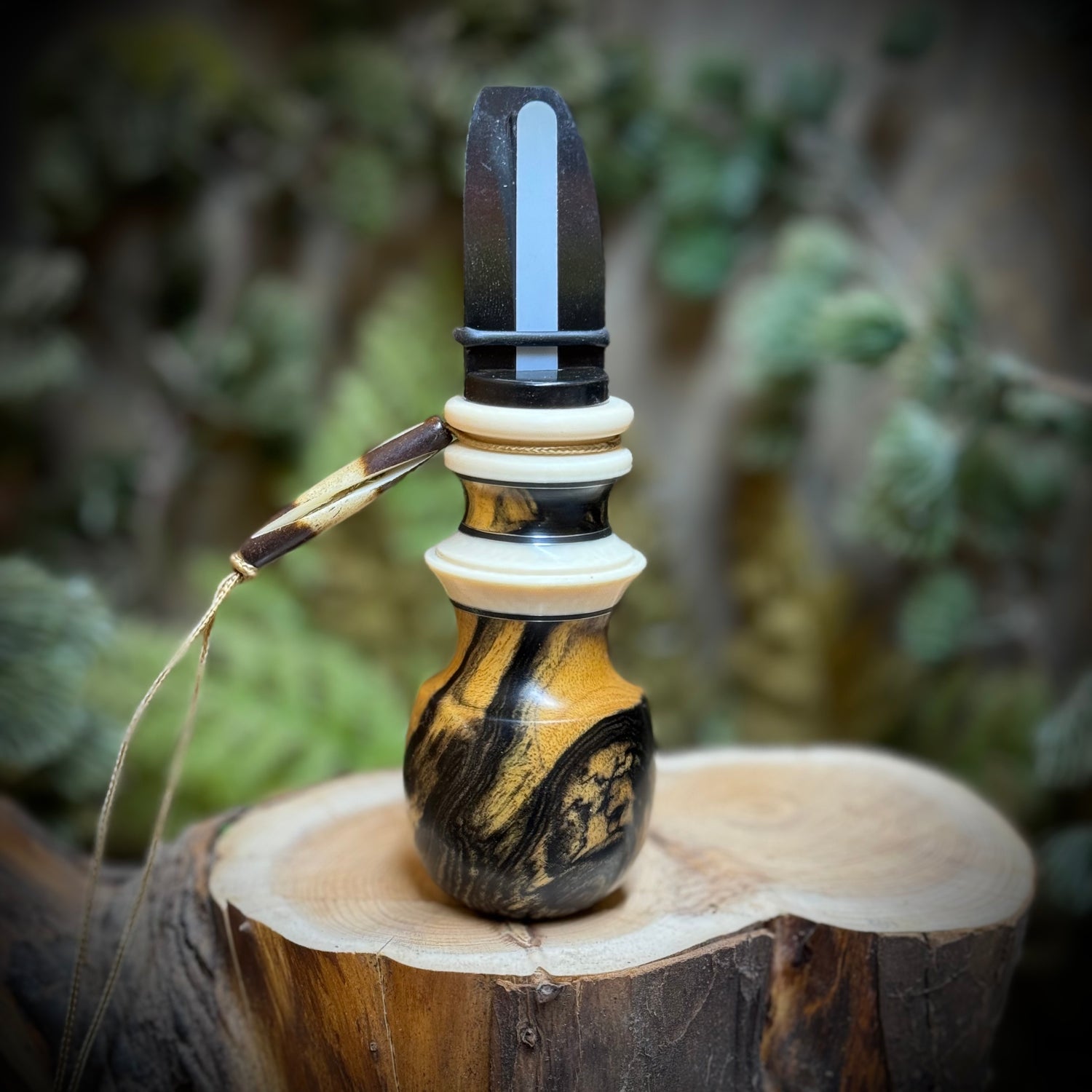 Black and white ebony elk call with custom black and brass inlays and faux ivory.
