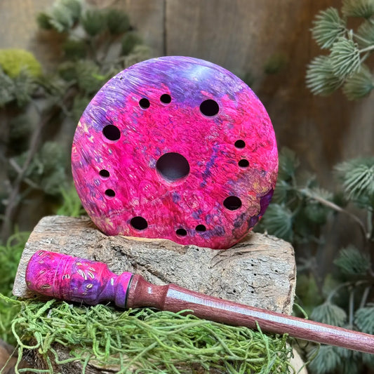 Maple Burl Hybrid Turkey Call with Purple and Pink died resin propped up behind a matching maple burl hybrid striker with detailed inlays and purpleheart wood stem