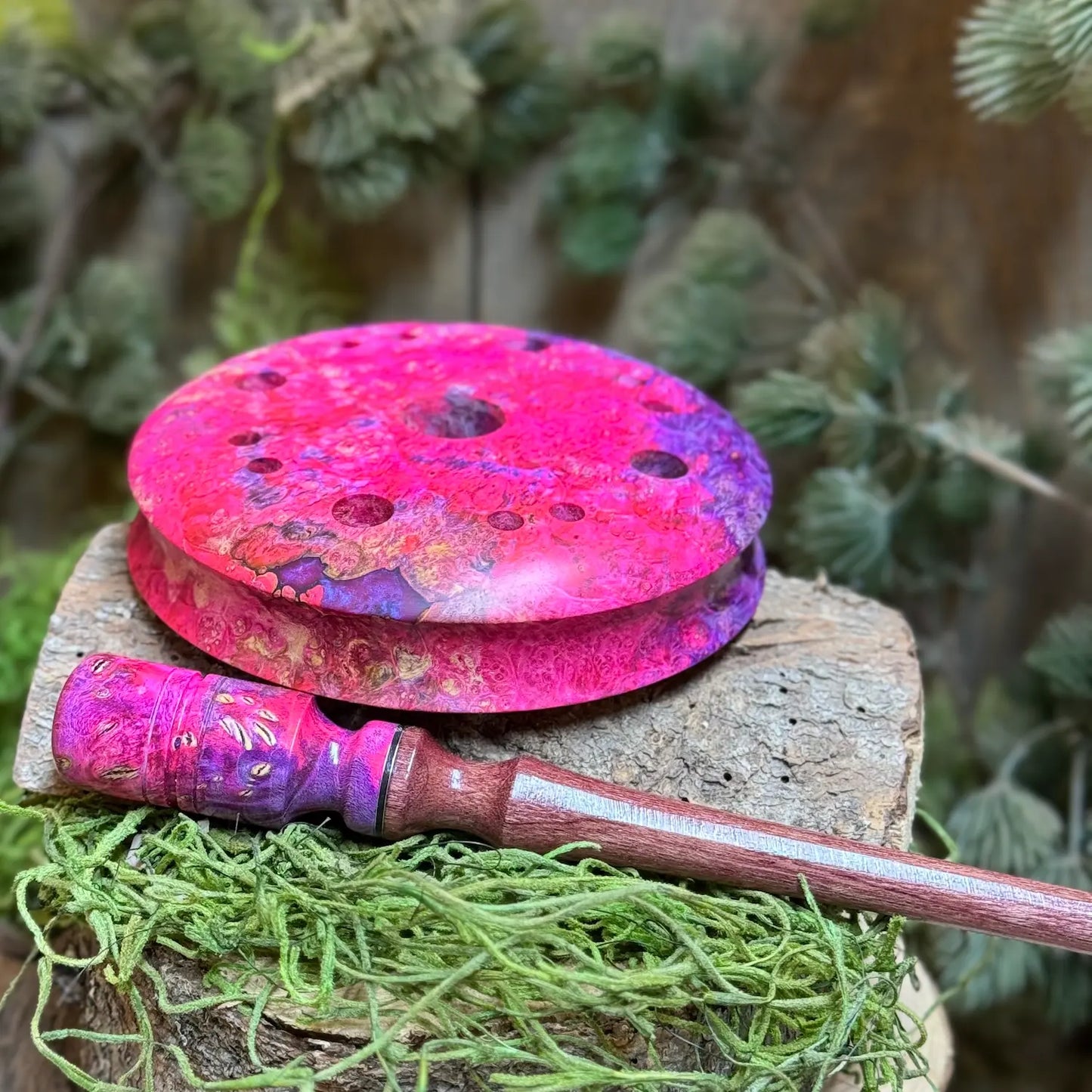 Maple Burl Hybrid Turkey Call with Purple and Pink died resin set flat to show curved contour grip behind a matching maple burl hybrid striker with detailed inlays and purpleheart wood stem