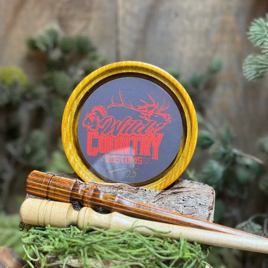 Osage Orange Pot Call with WCC logo under glass and an Ember Glow Laminate Striker and Black Locust Striker