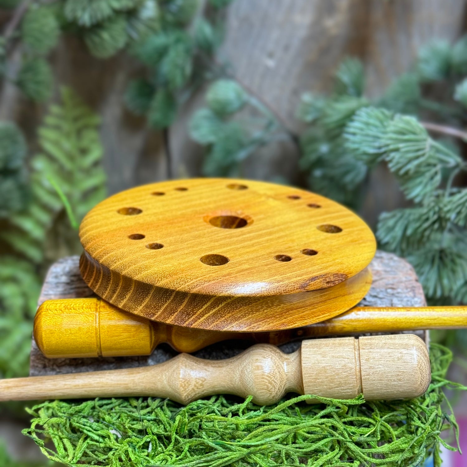 Osage Orange Turkey pot call displayed showing contoured edge for better grip set atop a matching striker and a lighter toned black locust wood striker