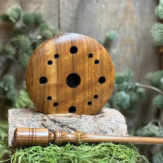 Shedua wood turkey pot call with a different sheen in the light when propped up above a Bolivian Rosewood striker.