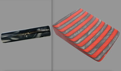 swatch of swirling black and silver tone acrylic rod next to Apple Jack laminate wood pattern of alternating red and grey color tones