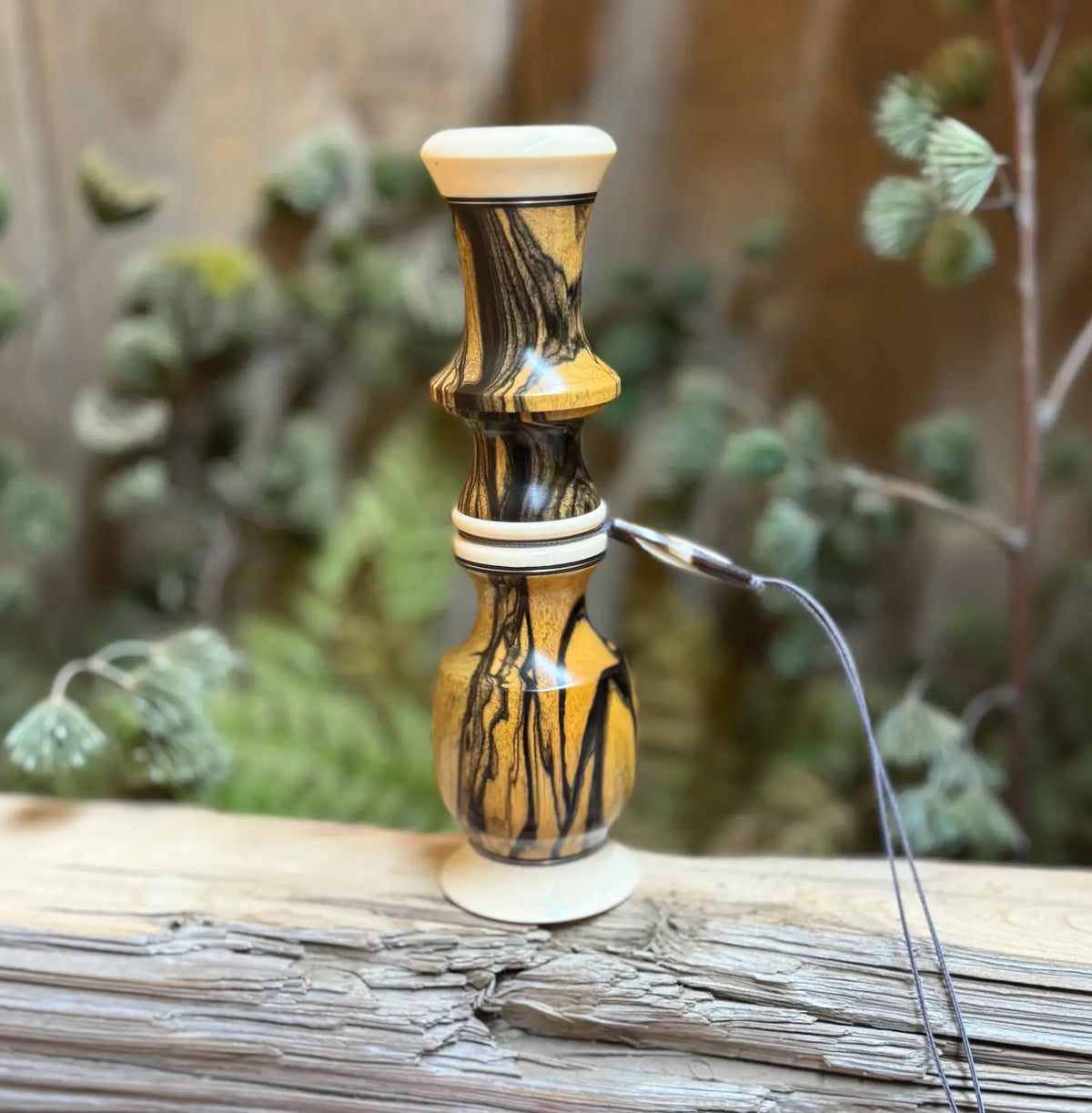 Black and white ebony wood deer grunt with thread-together design and lanyard groove using brass inlays and faux ivory accents