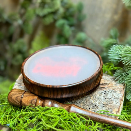 Bolivian Rosewood Turkey Call with frosted glass and Wild Country Customs logo in red upright with matching striker in foreground