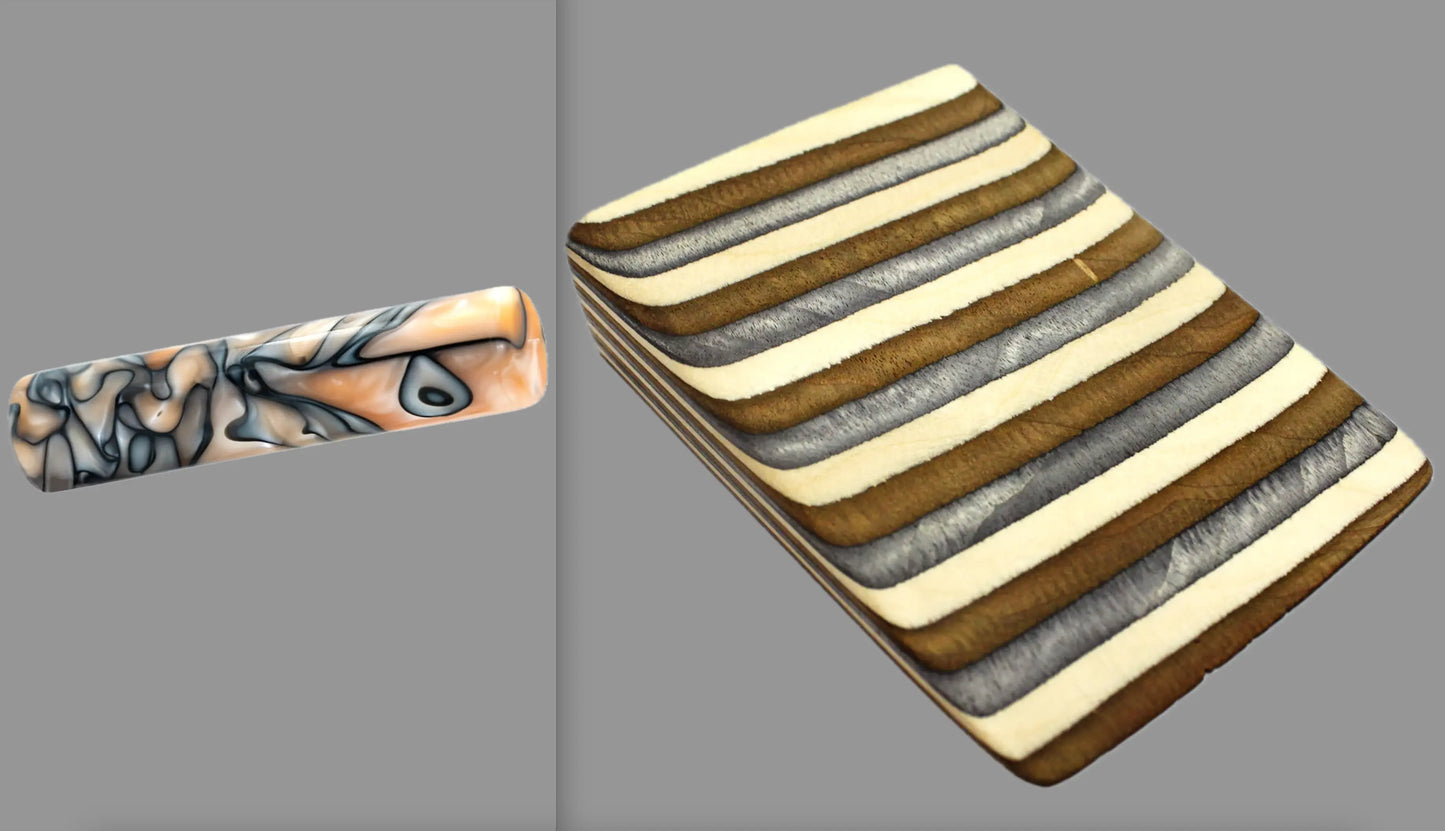 swatch of swirling black, silver, and creme tone acrylic rod next to Buckskin laminate wood pattern of alternating grey, copper, and creme tones separated by black dividing lines