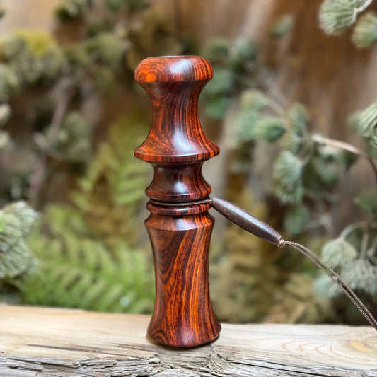 Handcrafted cocobolo wood owl hooter with rosy warm and radiant wood grain. The custom turkey locator call has a compact design with a custom lanyard. 