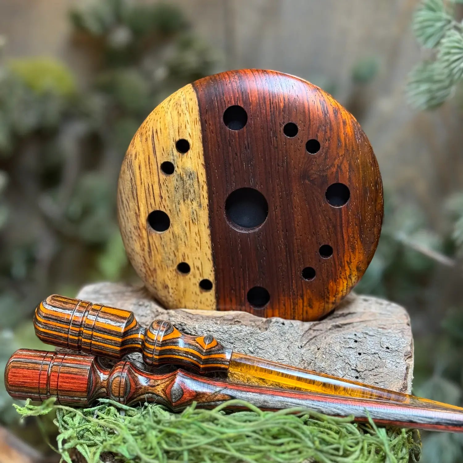 Cocobolo Turkey Call with sappy inclusion and two coordinating strikers in foreground made of laminate woods and acrylic stems