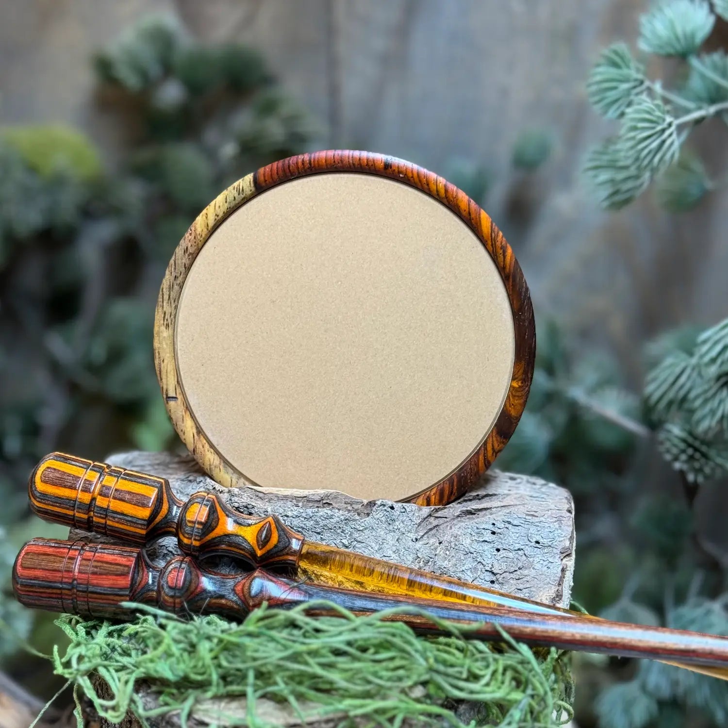 Cocobolo Turkey Call with sappy inclusion and ceramic surface propped up with two coordinating strikers in foreground made of laminate woods and ember acrylic stem