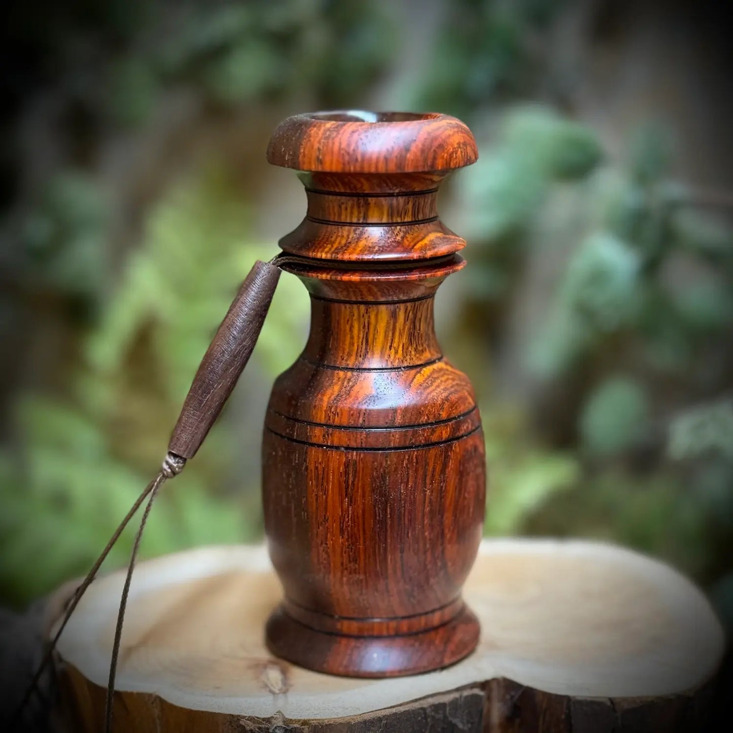 deep red and golden wood grains glow in this perfectly rounded grunt tube with compact design and wide chamber. The black detailed grooves and lanyard channel make this a comfortable fit in your hand when using the whitetail snort wheeze custom game call.