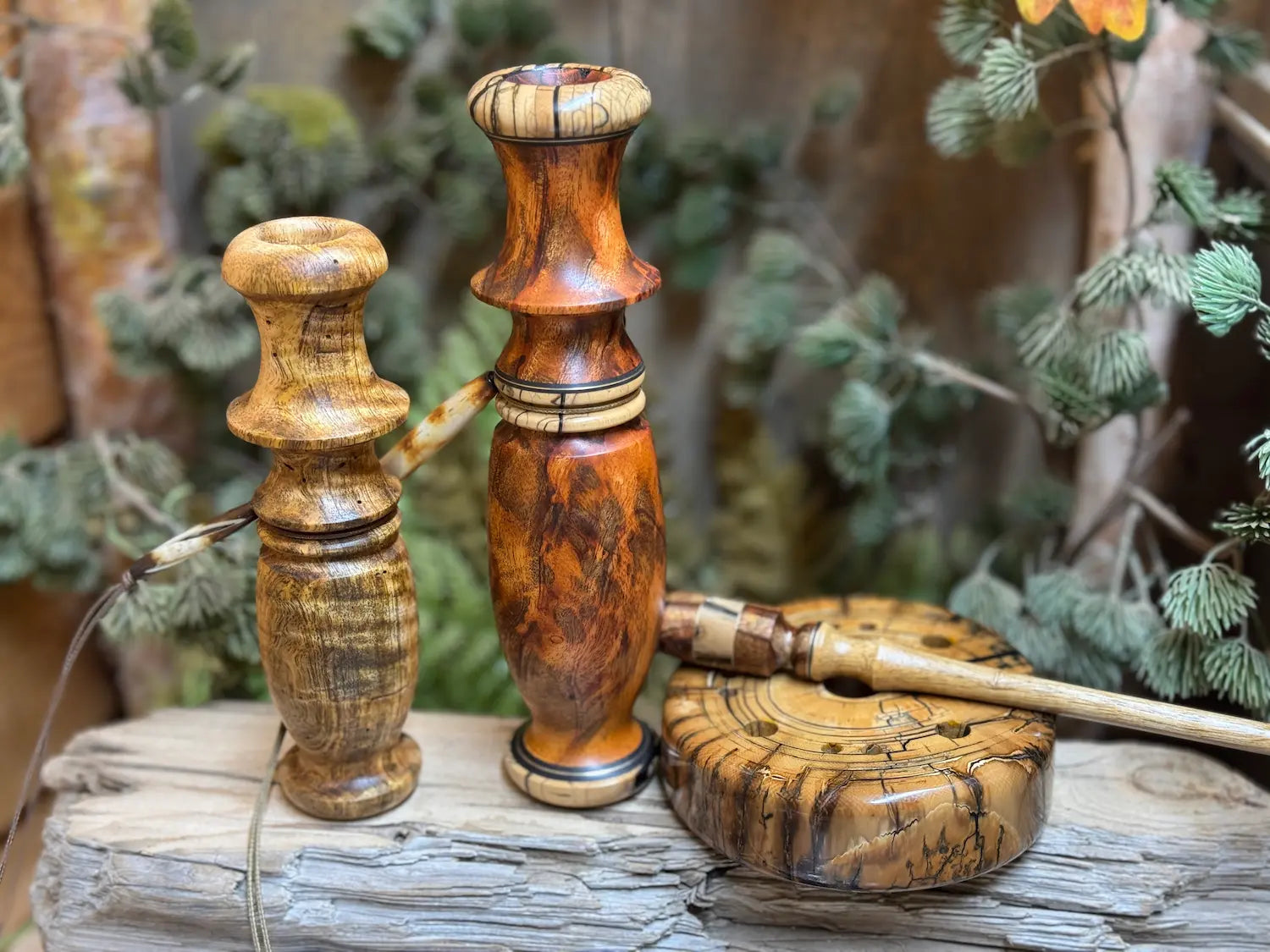 Custom Mammoth Tusk Turkey Pot Call with matching handmade striker. The persimmon wood striker has Asian Mahogany Burl and Mammoth Tusk head including custom inlays. Gallery photo shows a matching Asian Mahogany Burl Whitetail Grunt call with custom Mammoth Tusk and detailed inlays. These are pictured with a stunning golden shimmering Curly Mango wood custom compact whitetail Grunt Call. Stunning Collector's piece for display or to call in the next turkey or deer in the field.