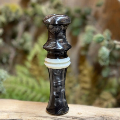 Short Reed Goose call made with the signature swirling acrylic patterns of silver and brown like smoky on carbon. HD Carbon Acrylic from Deadshot Polymer's with white central faux ivory ring with built-in lanyard groove.