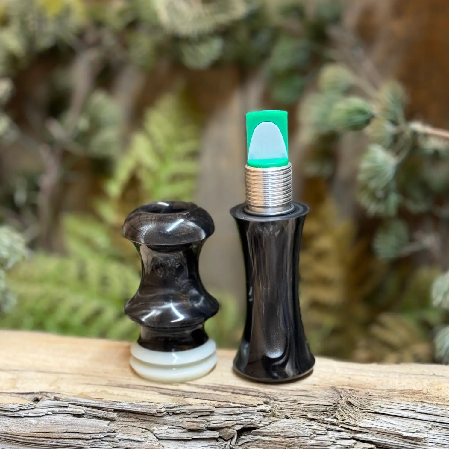 Short Reed Goose call sitting open with two parts, the thread-together design shows the short reed for the call inside the "guts" of the call. It's made with the signature swirling acrylic patterns of silver and brown like smoky on carbon. HD Carbon Acrylic from Deadshot Polymer's with white central faux ivory ring with built-in lanyard groove in the mouthpiece half.