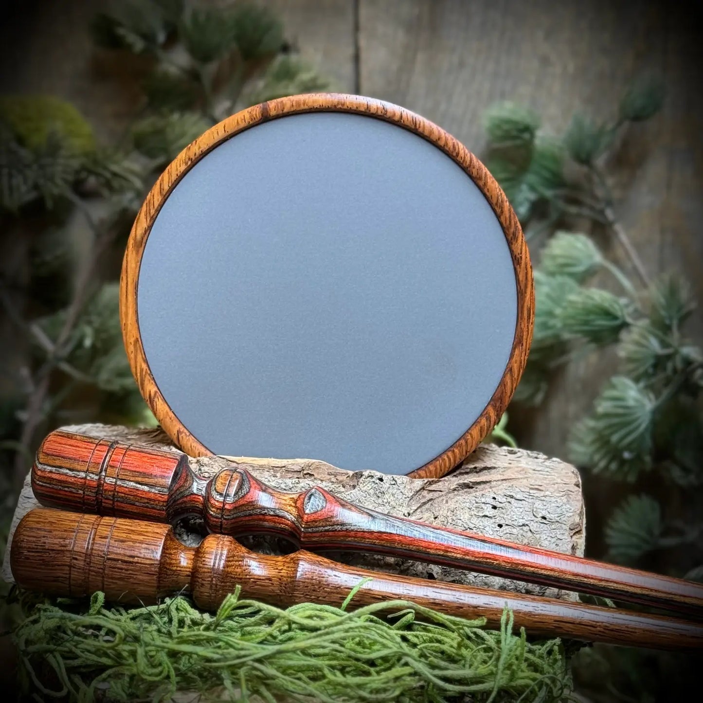 Honduran Rosewood Turkey Call with Anodized Aluminum surface propped up behinda laminate wood striker and a honduran rosewood striker