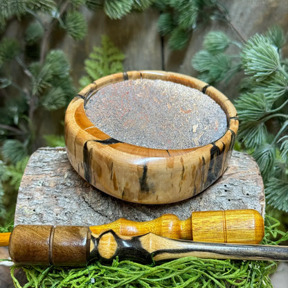 Rare Mammoth Tusk Turkey Call with Dinosaur bone surface laying flat to show profile of figuring on the side of the pot call and two premium strikers laying crisscross in foreground