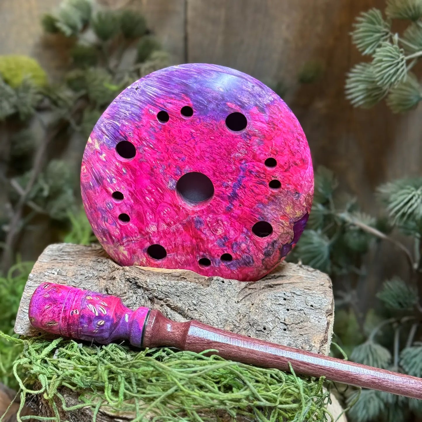Maple Burl Hybrid Turkey Call with Purple and Pink died resin propped up behind a matching maple burl hybrid striker with detailed inlays and purpleheart wood stem