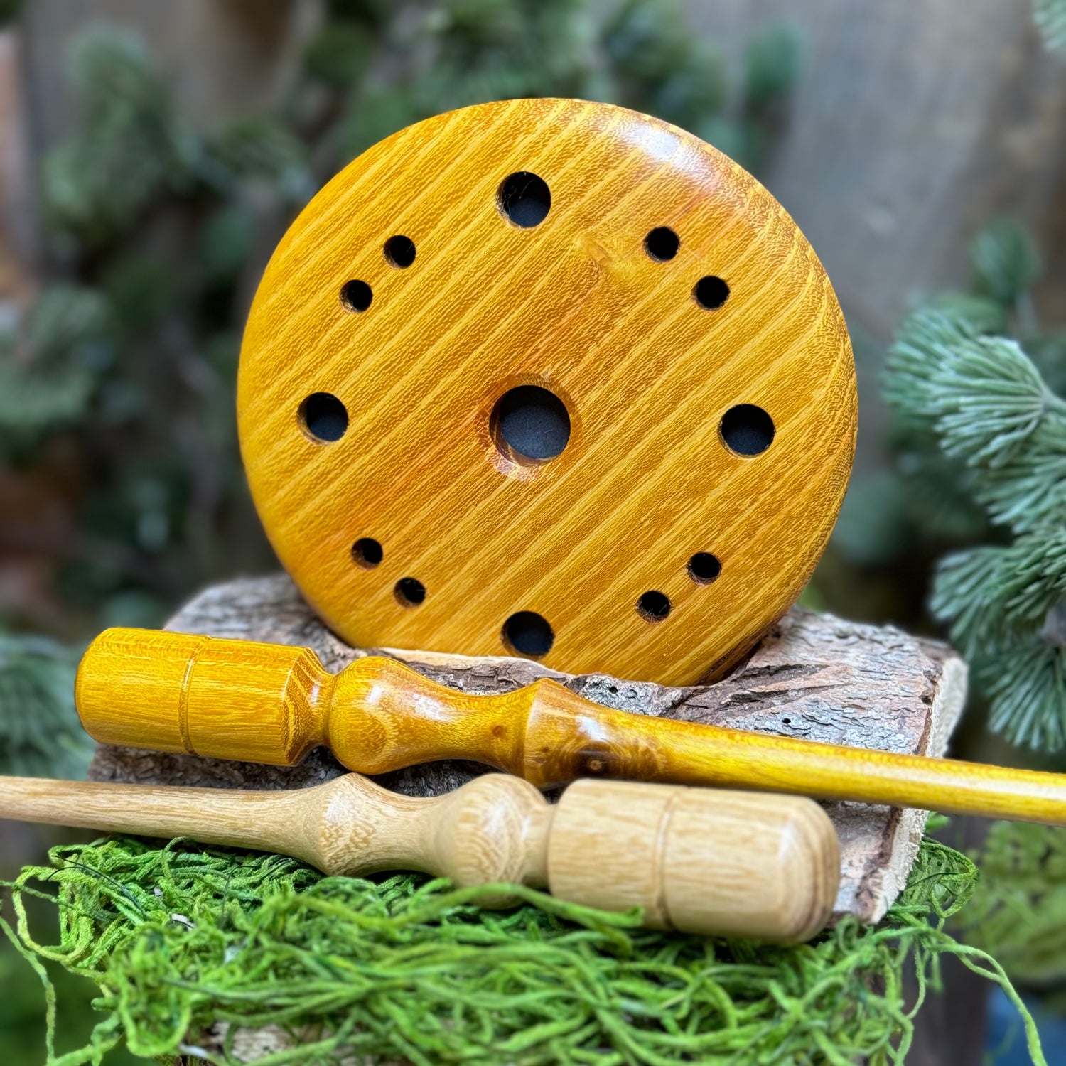 Osage Orange Turkey pot call displayed upright behind a matching striker and a lighter toned black locust wood striker