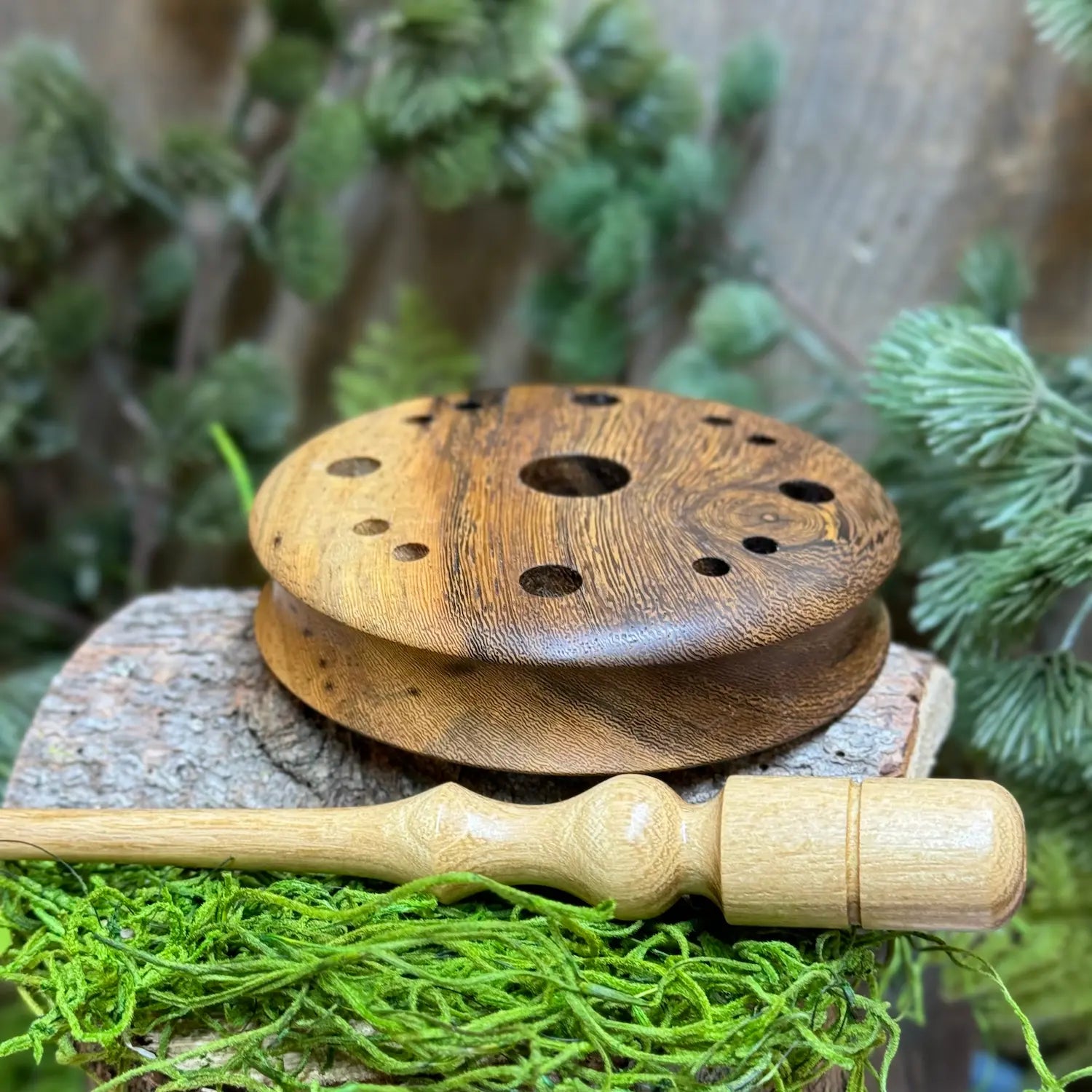 Pheasantwood Turkey Pot Call with lighter sapwood contrasts with warmer wood figuring set atop a lighter toned black locust wood striker