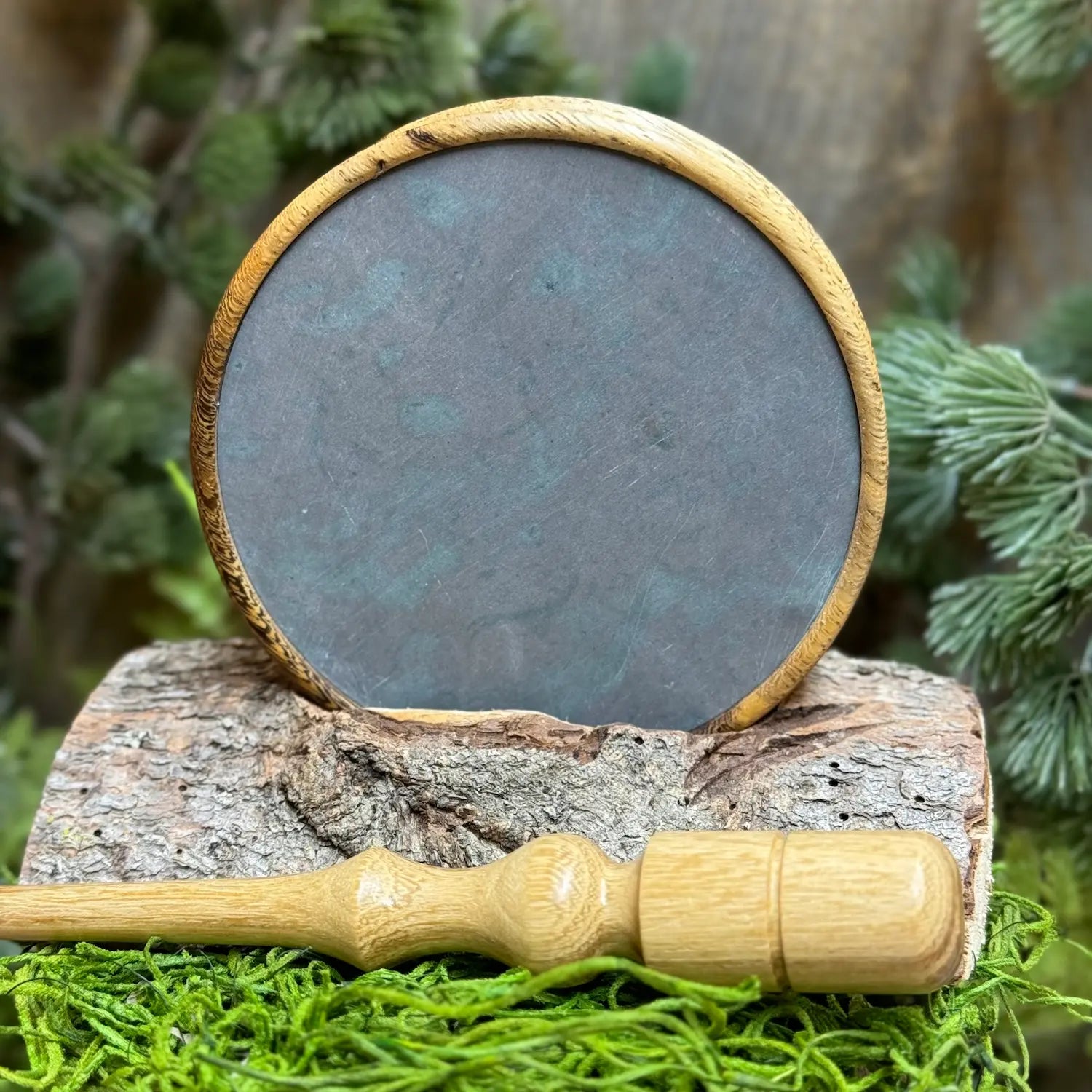 Pheasantwood Turkey Pot Call with contrasting sappy and dark tones displayed with lighter toned black locust wood striker in foreground.