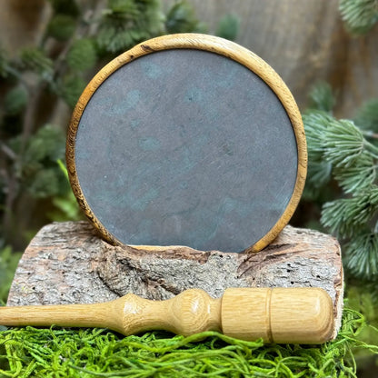 Pheasantwood Turkey Pot Call with contrasting sappy and dark tones displayed with lighter toned black locust wood striker in foreground.