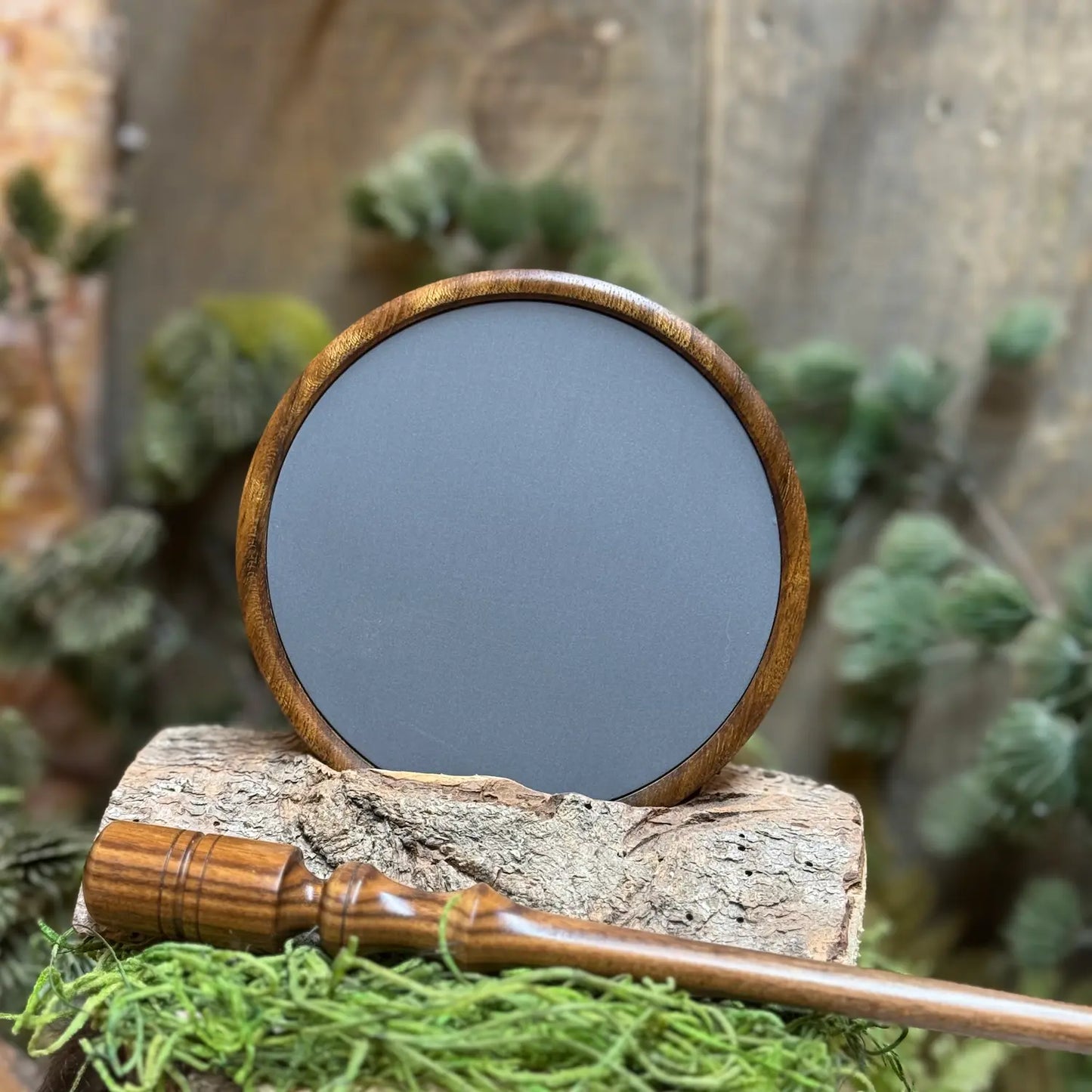 Shedua wood turkey pot call with a hard anodized aluminum surface propped up above a Bolivian Rosewood striker.