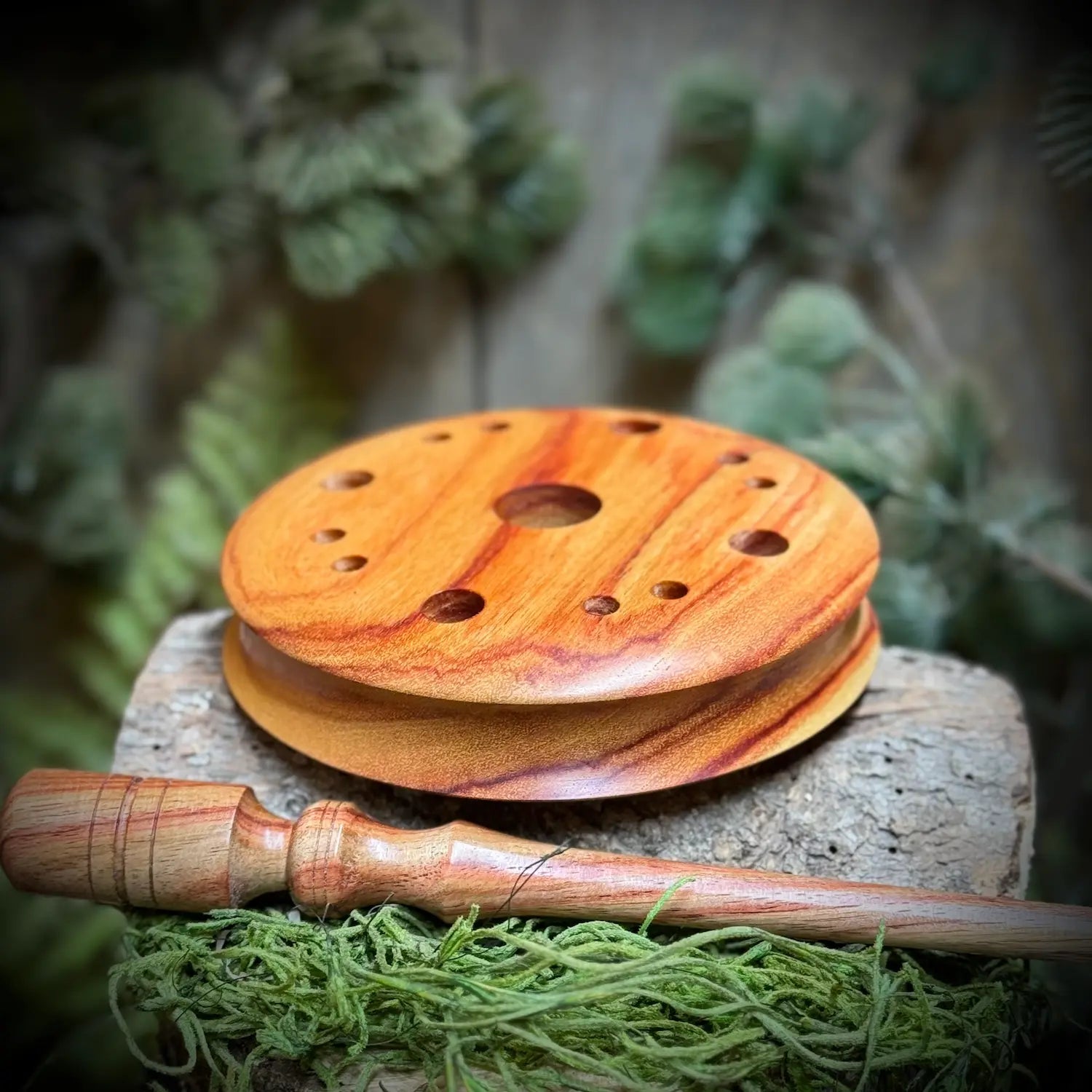 Tulipwood Turkey pot Call rested face down showing contoured edge next to a matching tulipwood striker