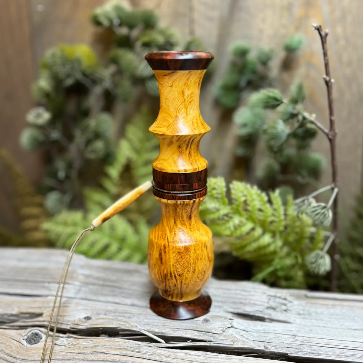 Yellow Cedar Burl Whitetail Grunt with snakewood accents and a bone bead on a lanyard